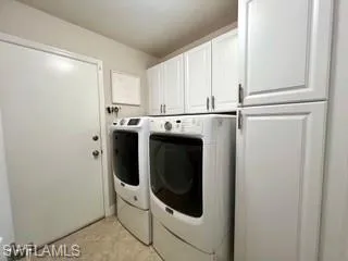 Laundry room featuring cabinet space and independent washer and dryer