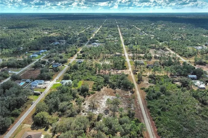 Aerial overview of property's location featuring a forest