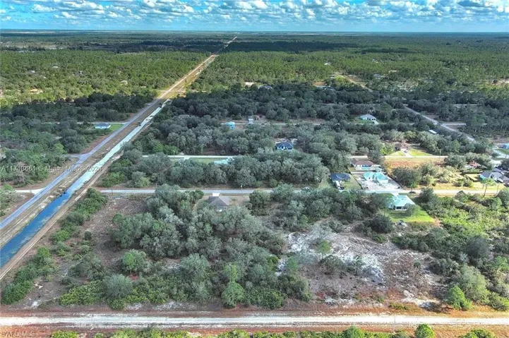 Aerial overview of property's location featuring a heavily wooded area