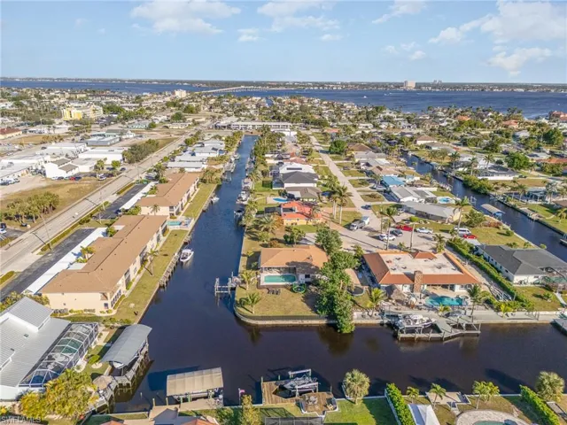 Birds eye view of property with a water view