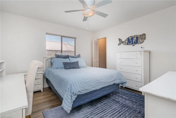 Bedroom with dark wood-type flooring and ceiling fan