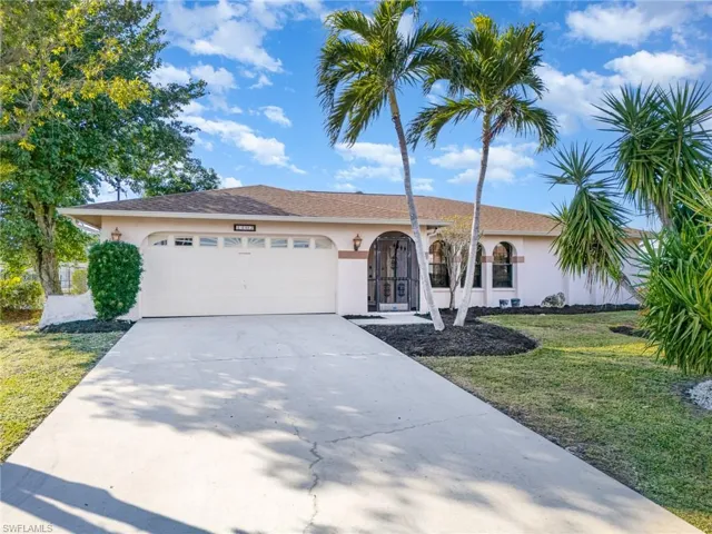 Single story home featuring a garage and a front yard