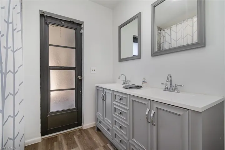 Bathroom featuring vanity and wood-type flooring