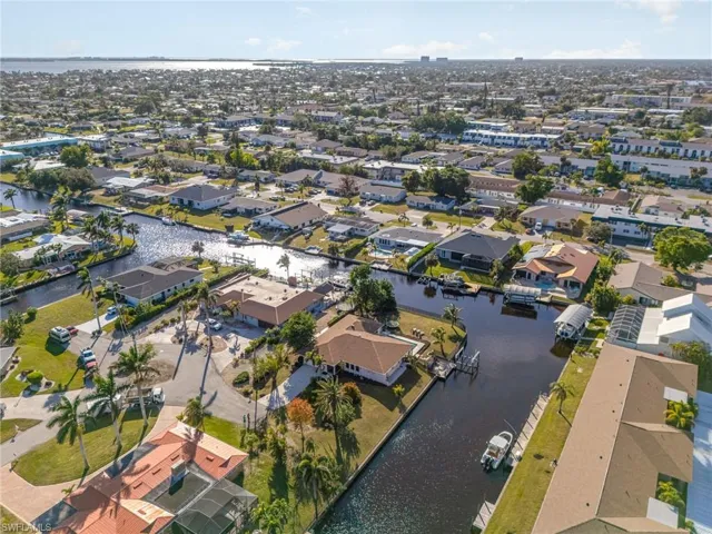 Birds eye view of property with a water view