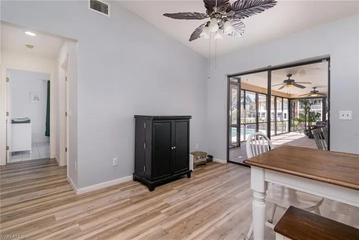 Dining room featuring lofted ceiling, light hardwood / wood-style floors, and ceiling fan