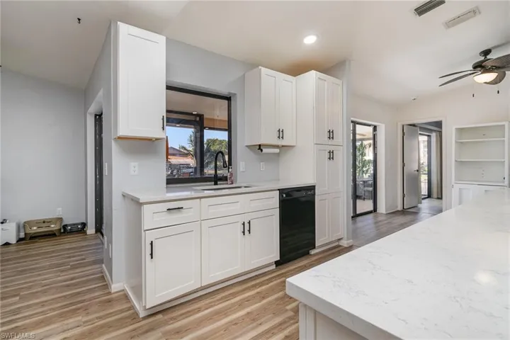 Kitchen with white cabinetry, sink, plenty of natural light, and dishwasher