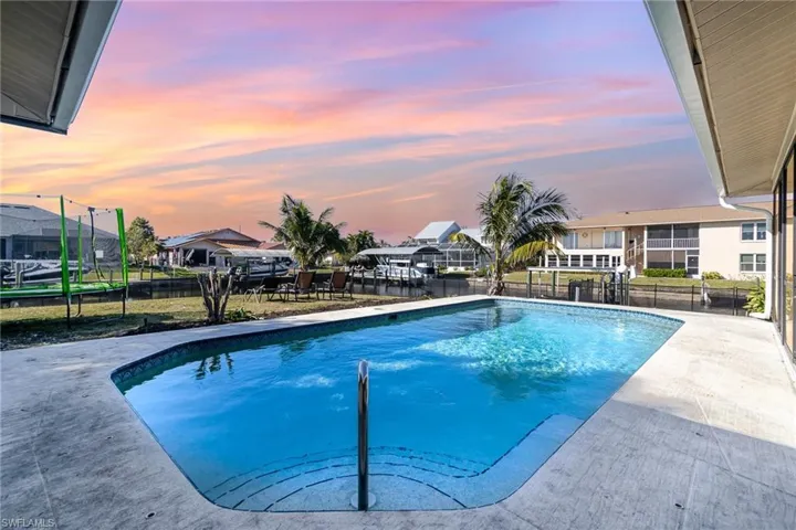 Pool at dusk with a trampoline