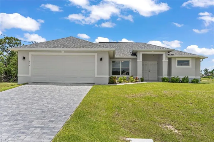 View of front of home featuring a garage and a front yard