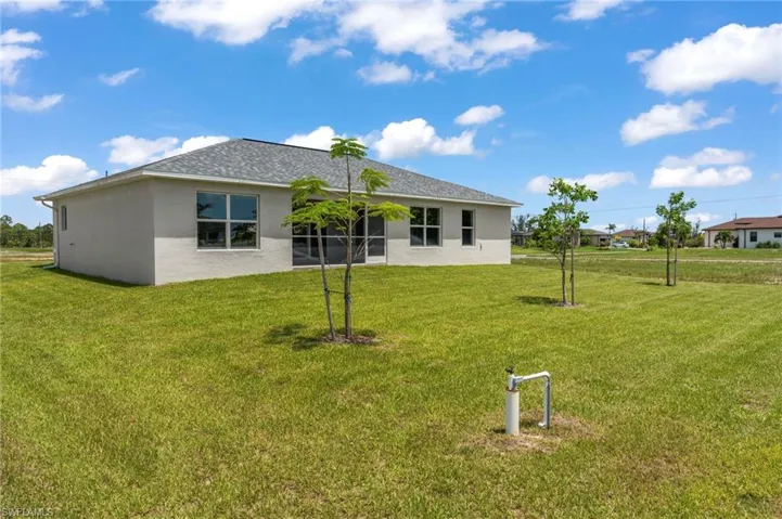 Back of house featuring a yard