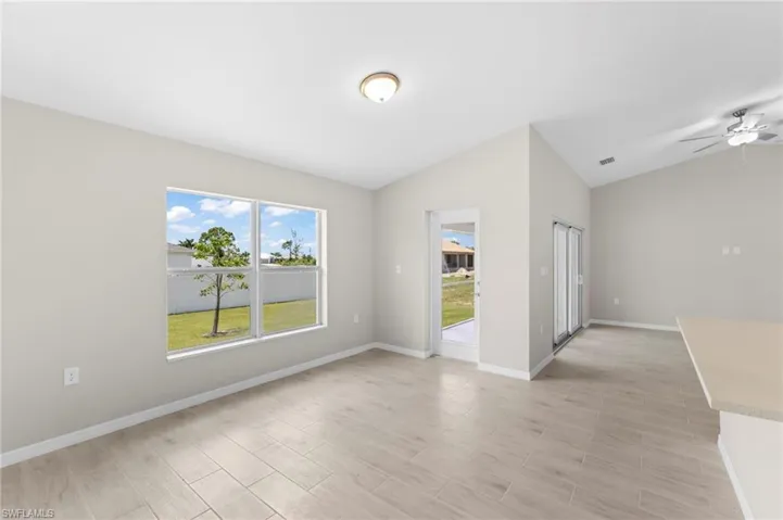 Spare room with vaulted ceiling and ceiling fan
