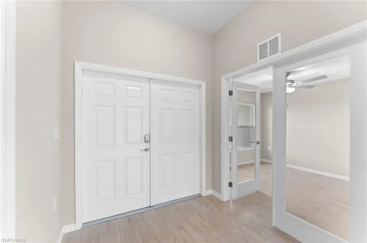 Foyer entrance featuring ceiling fan and light hardwood / wood-style floors