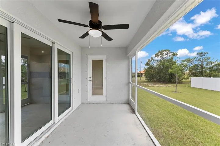Unfurnished sunroom featuring ceiling fan