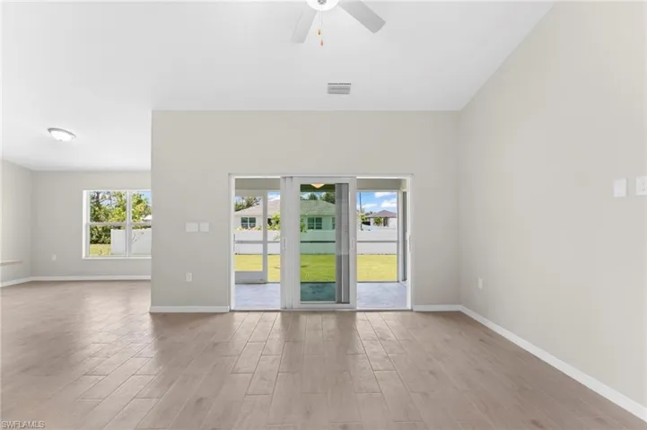 Empty room with light hardwood / wood-style flooring and ceiling fan