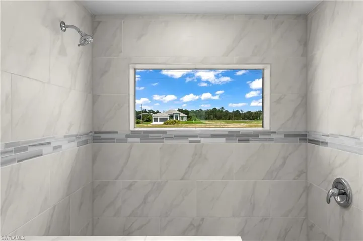 Bathroom with tile walls and a tile shower