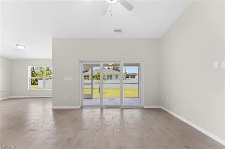 Unfurnished room featuring light hardwood / wood-style flooring, a wealth of natural light, and ceiling fan