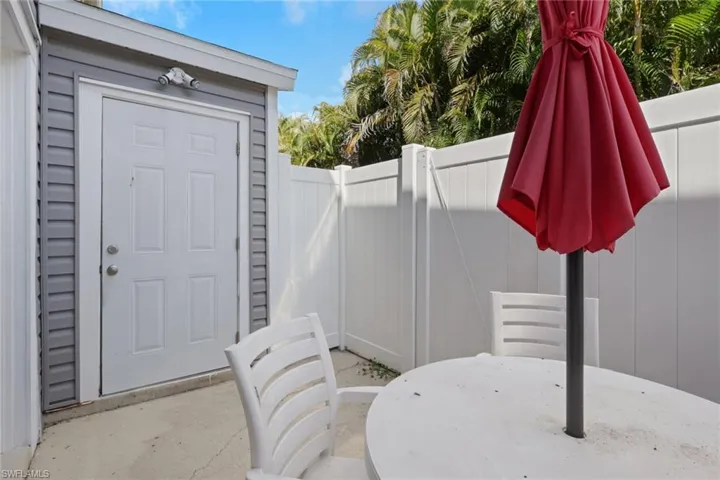View of exterior entry with a patio area