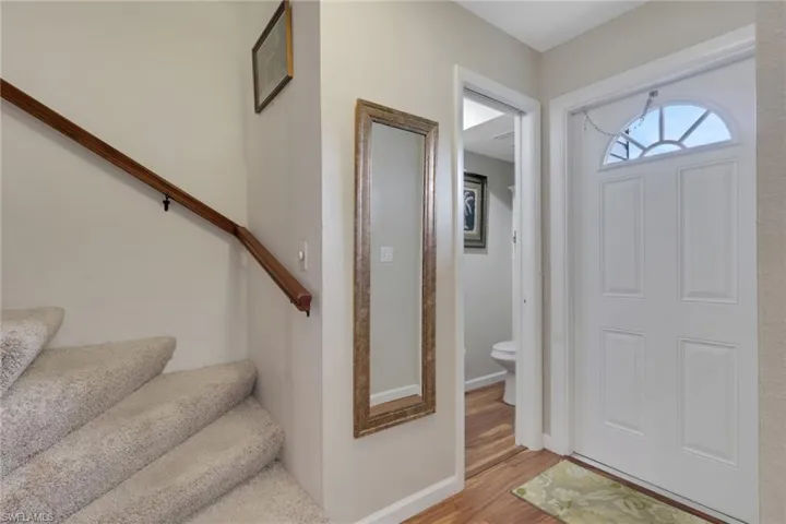 Foyer featuring stairway and light wood-style flooring