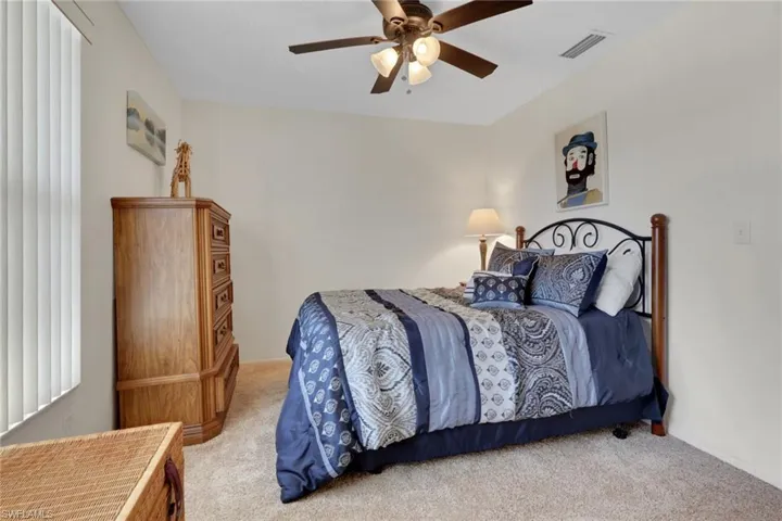 Bedroom featuring a ceiling fan and carpet floors