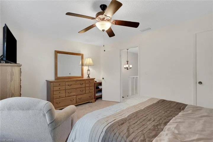 Carpeted bedroom with ceiling fan