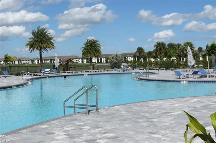 Community pool featuring a patio and a residential view