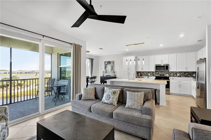 Living area featuring light tile patterned floors, ceiling fan, and recessed lighting