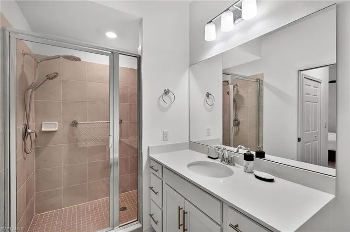 Bathroom featuring vanity, a stall shower, and recessed lighting