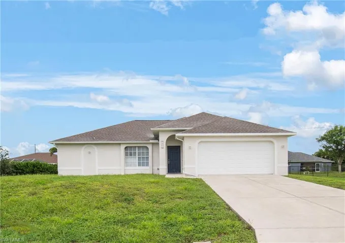 Single story home with stucco siding, a shingled roof, driveway, and an attached garage