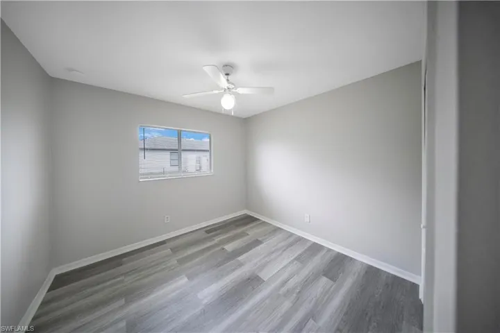 Spare room featuring light wood-type flooring and a ceiling fan