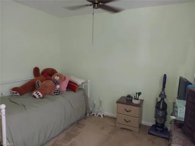 Bedroom featuring ceiling fan and carpet floors