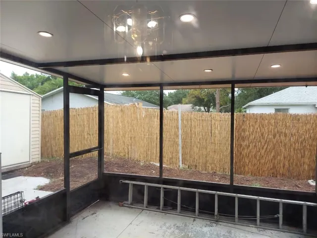 Unfurnished sunroom featuring a notable chandelier