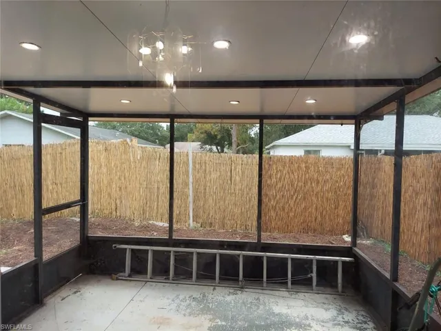 Unfurnished sunroom with a notable chandelier