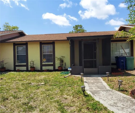 Single story home with a front lawn