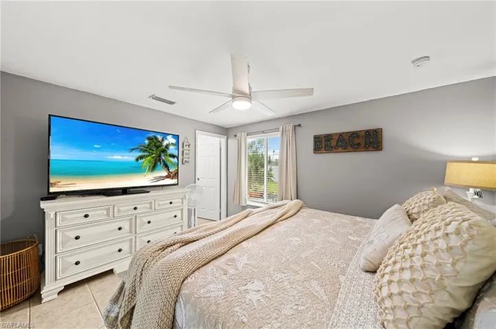 Bedroom with light tile patterned flooring and a ceiling fan