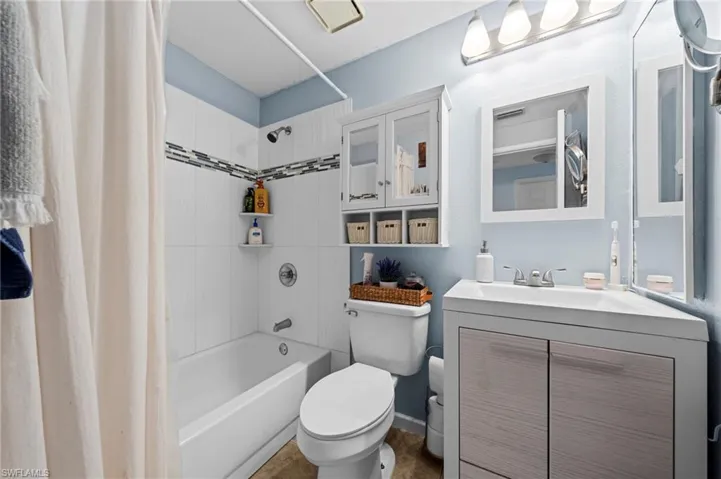Full bathroom with shower / bath combo and vanity