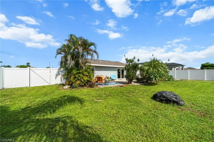 Fenced backyard with a patio