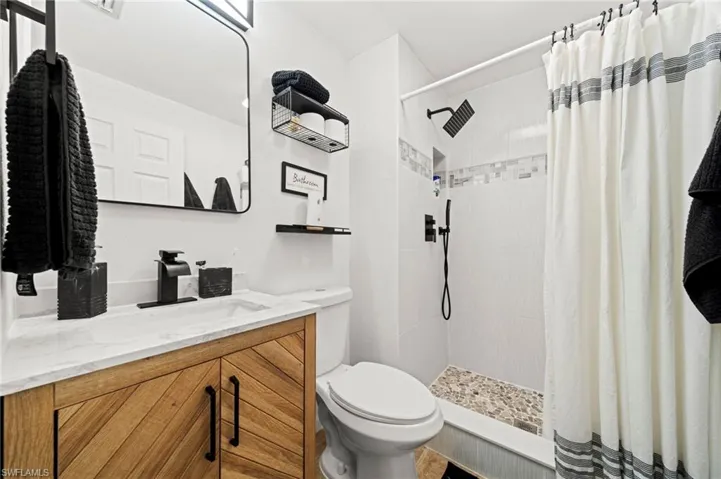 Full bathroom featuring vanity and a tile shower