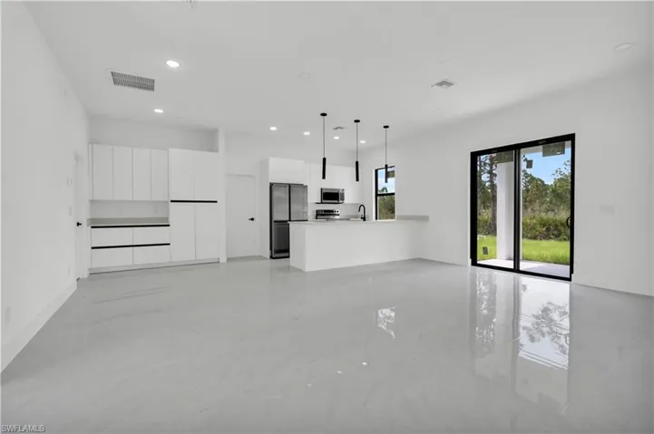 Unfurnished living room featuring recessed lighting and a sink
