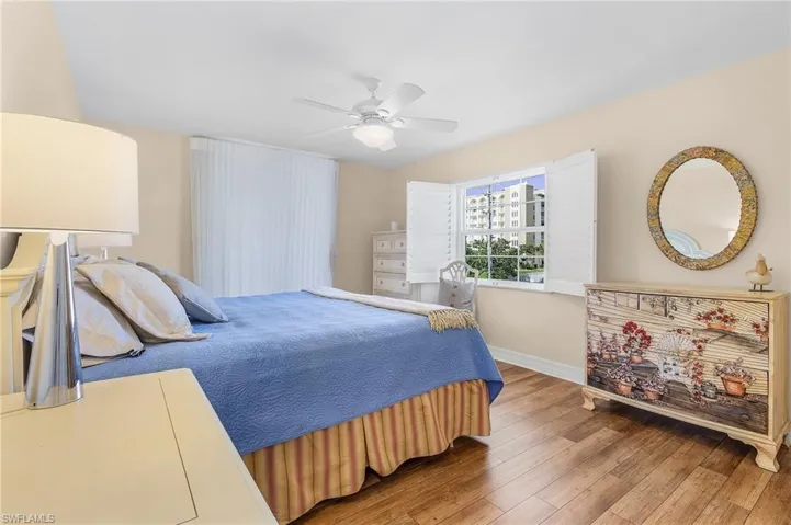 The main bedroom is conveniently located on the main living level, offers views of the Gulf of Mexico, has access to the wrap-around lanai and features an en-suite bathroom.