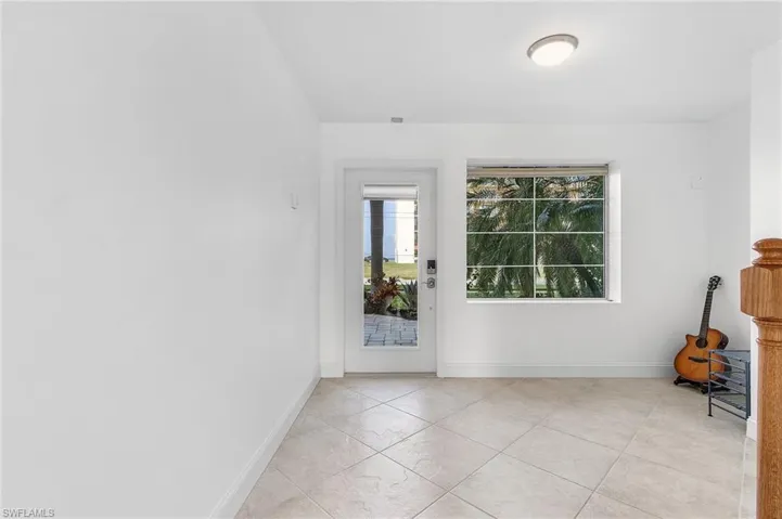 The entrance of the home accesses a stairwell, a private elevator, an attached two-car garage, a powder room, and a private, pool-side patio where you can walk right out to the dock with your private boat slip.