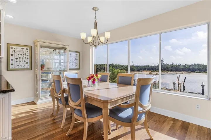 Everyone gets a seat by the window for waterside dining at this home! Enjoy watching the dolphins and manatees, and all the watercraft go by on the bay right in your own backyard!