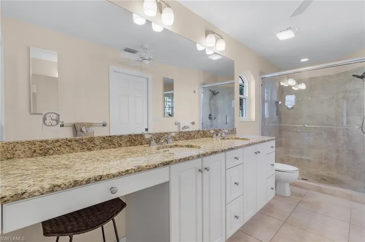 The main bedroom has an ensuite Bathroom with walk-in shower, vanity with granite countertop and dual sinks, and a walk-in closet with custom closet system.