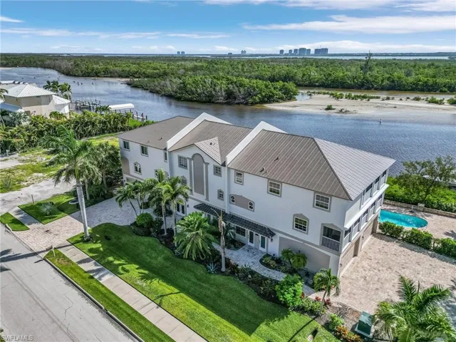 Aerial view the 3 unit condo building.  The Southside end unit is it!  The spacious home includes 4 bedrooms, 3 full baths, two half baths, an attached two-car garage, a boat slip with lift and deeded beach access across the street.