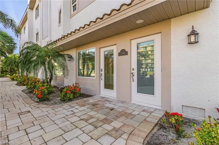 A pavered walkway takes you to the main entrance of the bay-front home.