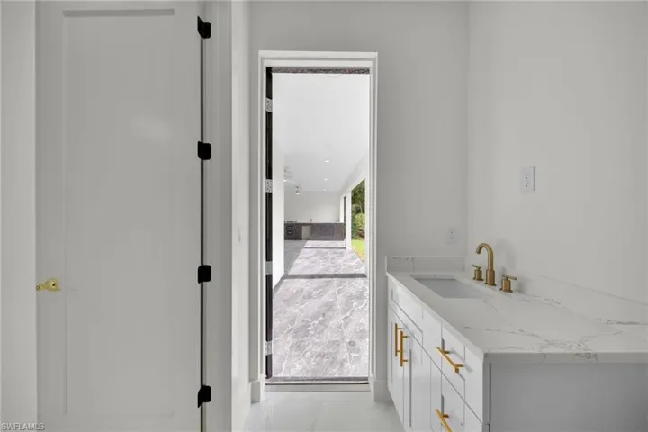 Bathroom with marble finish floors and vanity