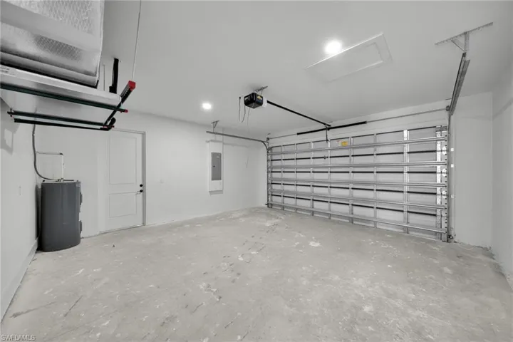 Garage with electric water heater and electric panel