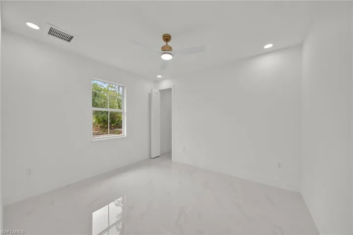 Unfurnished room featuring recessed lighting, marble finish flooring, and ceiling fan
