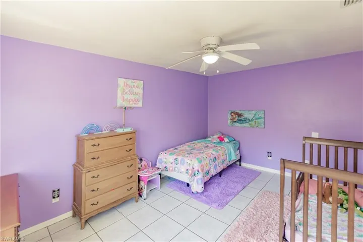 Bedroom featuring ceiling fan and light tile patterned flooring