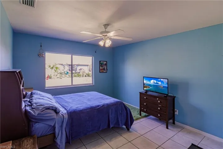 Tiled bedroom with ceiling fan
