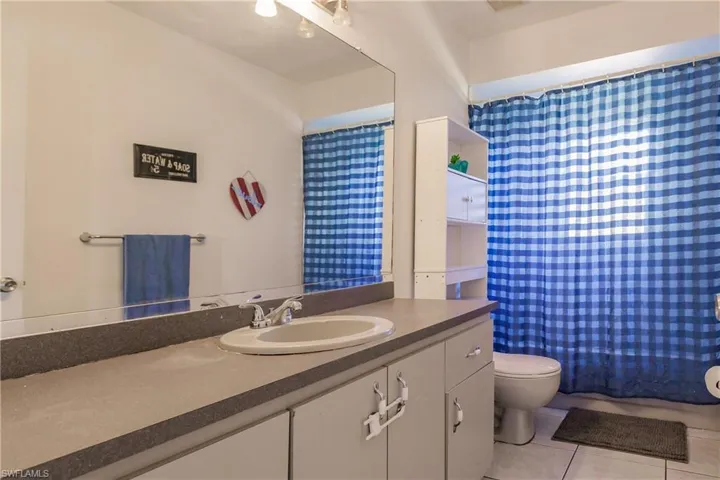 Bathroom featuring tile patterned floors, vanity, and toilet