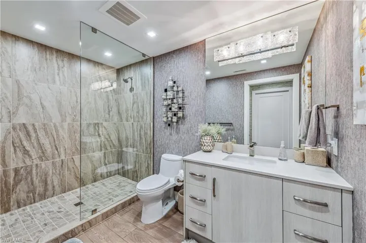 Full bathroom with a walk in shower, vanity, and recessed lighting
